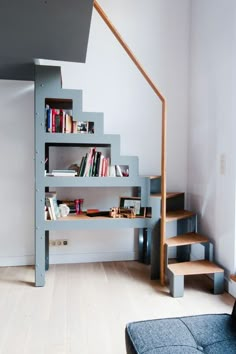 there is a bookshelf next to the stairs