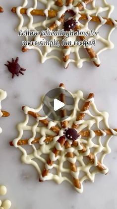 some kind of snowflake with white icing on it and chocolate sprinkles