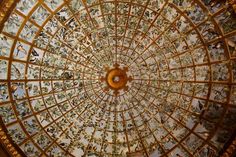 an ornate glass ceiling with birds and flowers on it