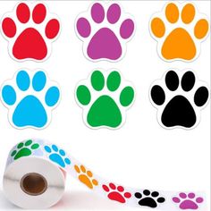 a roll of colorful paw prints on a white background next to some stickers with different colors