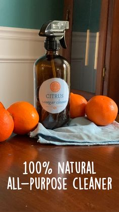 oranges on a table with a bottle of natural all - purpose cleaner