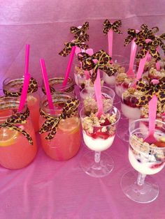 desserts are arranged in small glasses on a table