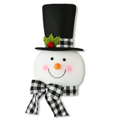 a snowman wearing a top hat and bow tie with holly leaves on it's head