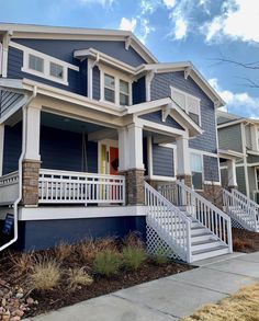 a row of houses with white balconies and blue siding