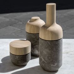 two wooden vases sitting next to each other on a table