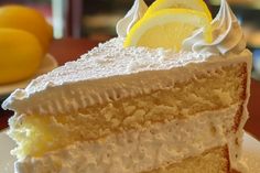 a slice of cake with white frosting and lemons