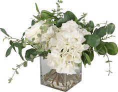 a vase filled with white flowers and greenery