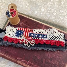 a pair of scissors sitting on top of a table next to a piece of lace