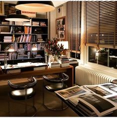 a room with several bookshelves and chairs in it