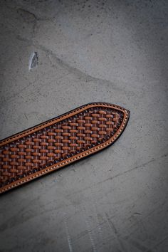 a close up of a piece of leather on the ground with no one around it