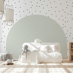 a living room with polka dot wallpaper and white furniture