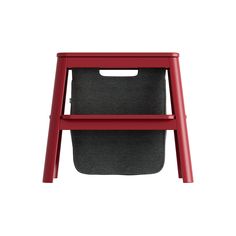 a red plastic chair with a black seat and grey fabric on the bottom, against a white background