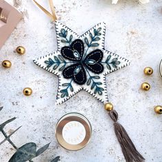 a star ornament on a table next to other ornaments