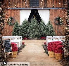 an outdoor ceremony set up with white chairs and red blankets on the back of them