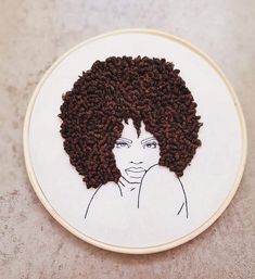 an embroidery pattern with a woman's face on it