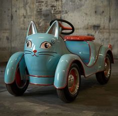 a blue toy car with a cat face painted on it