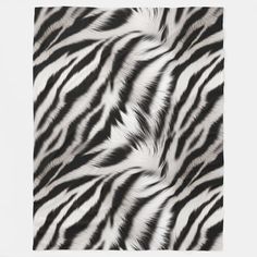 a black and white zebra print blanket on top of a tablecloth with the image of an animal's fur