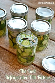 the best refrigerator dill pickles in a mason jar on a picnic table with text overlay that reads, the best refrigerator dill pickles