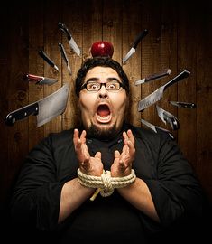 a man with an apple on top of his head surrounded by knives and rope around him