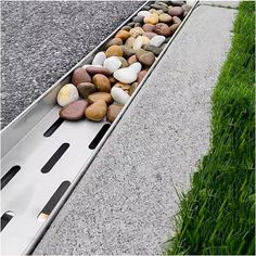 some rocks and grass on the side of a road