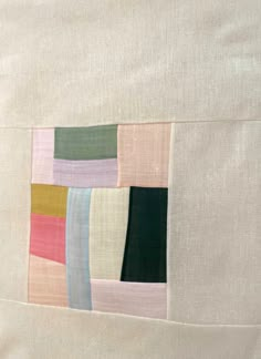 a piece of fabric with different colored squares on the front and back side of it