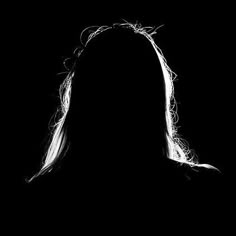 the silhouette of a woman with long hair