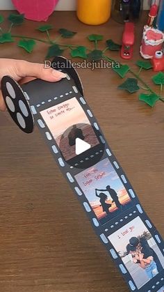 someone is holding up a film strip with pictures on it and the film roll has been cut out