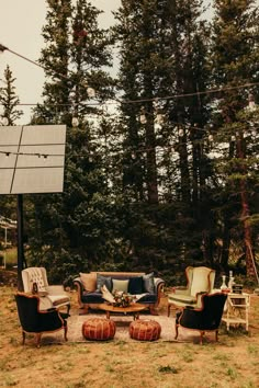 an outdoor seating area with chairs, couches and a solar panel in the background