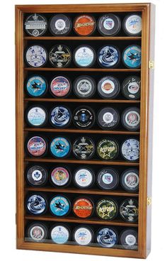 the hockey puck display case is made from wood and holds all kinds of pucks