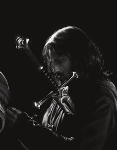 a black and white photo of a man playing the violin