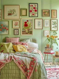 a bedroom with green walls and lots of pictures on the wall above the bedspread