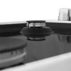 a black and white photo of a faucet in a sink