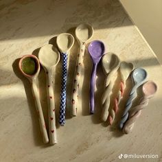 six spoons lined up on a counter top