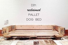 a dog bed made out of pallet wood with the words diy reclaimed written on it