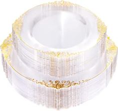 a stack of white plates with gold trimmings