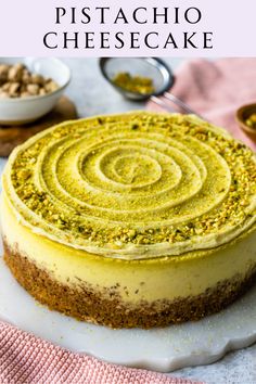 a close up of a cake on a plate with the words pistachio cheesecake