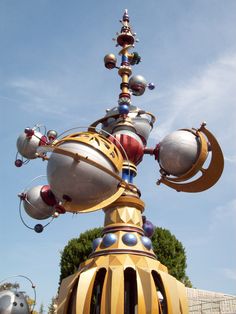 a large metal structure with many balls on it's top and two circles at the base