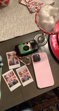 a table topped with pictures and other items next to a cup on top of a table