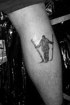 a man with a ski tattoo on his leg