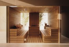 an indoor sauna with wooden steps and benches