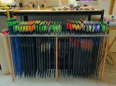 there are many pens and pencils on the rack in this shop, all lined up