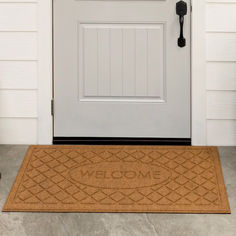 a welcome mat is placed in front of a door