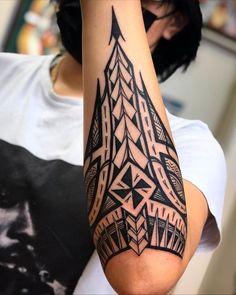 a person with a black and white tattoo on their arm