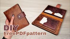 two handmade leather wallets are shown with one being held up by the other