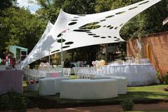 an outdoor wedding setup with tables and chairs