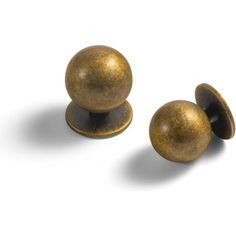 two brass colored knobs on white background