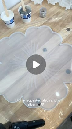 a video demonstrating how to make an acrylic flower design on a wood table