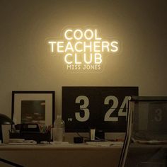 the neon sign above the desk reads cool teachers club miss jones 23 22 and is lit up