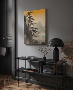 a painting hangs on the wall next to a shelf with books and a lamp in it