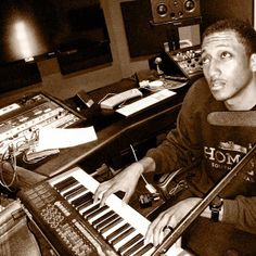 a man sitting in front of an electronic keyboard